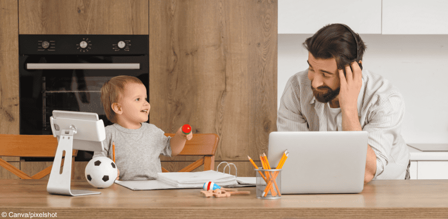 Elternzeit: Ein Vater arbeitet und daneben sitzt ein Baby.